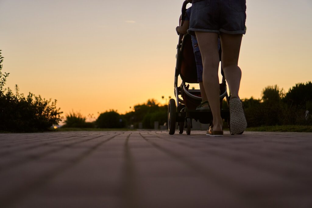 mom walking postpartum with stroller postpartum walking guide